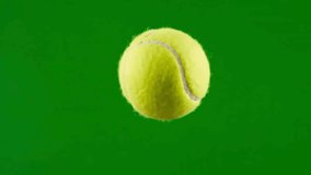 A vibrant tennis ball floats against a solid green backdrop perfect for sports or recreation themes - Powered by Shutterstock - Get 15% off with code: PIKWIZARD15