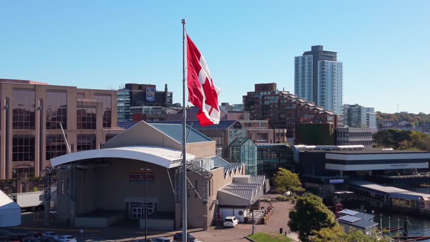 Beautiful Cinematic Drone View Of A Waving Canada Flag Overlooking Halifax Business District And Waterfront. Perfect Visual For National Celebration And Canadian Heritage Themes.