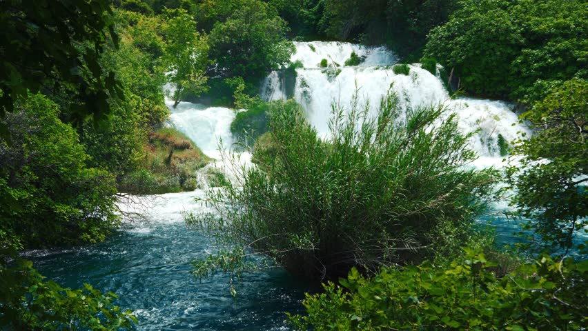 Idyllic waterfall landscape with blue water cascades and lush vegetation, Krka National Park Croatia