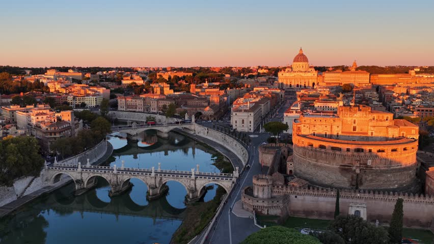 orbiting drone shot of river Tiber and Castel Sant Angelo in Italian capital Rome at sunrise, historic Roman architecture, aerial view of Sant Angelo bridge, travel in Rome. High quality 4k footage