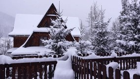 Snow wooden cabin in a quiet winter wonderland with falling snowflakes and frosted trees. Zakopane, Poland - Powered by Shutterstock - Get 15% off with code: PIKWIZARD15