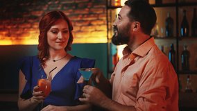 Man complimenting red-haired woman, clinking cocktail glasses together, flirt - Powered by Shutterstock - Get 15% off with code: PIKWIZARD15
