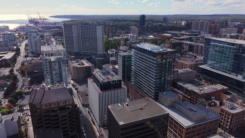  Aerial View Nova Scotia Capital Captured In Stunning Cinematic Style. Drone View Shows Downtown High-Rises, Calm Ocean Bay, And White Yachts Resting By The Marina In Fall.