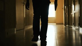 Small school boy walks with book down dark hallway toward light. Lonely silhouette child walking down dark hallway toward lit door. Child journey toward light. Elementary school looks to kid future - Powered by Shutterstock - Get 15% off with code: PIKWIZARD15