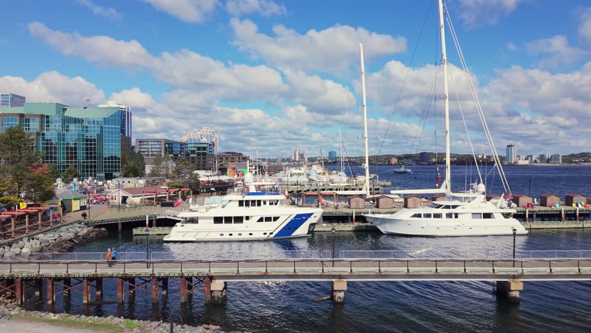 Aerial View Of Business District In Nova Scotia Capital. Golden Light Highlights Sailboats Docked Near Skyscrapers, Capturing A Cinematic And Peaceful Mood. Halifax, Canada