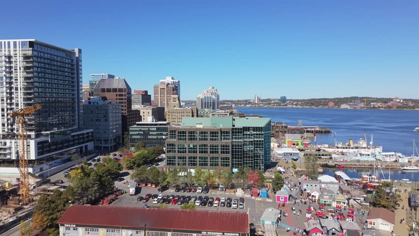 Drone Shot Of Canadian Waterfront Cityscape. Halifax Harbor Filled With White Boats, Calm Waters, And Towering Architecture During Autumn.Modern Skyscrapers, Oceanfront Marina, And Clear Halifax