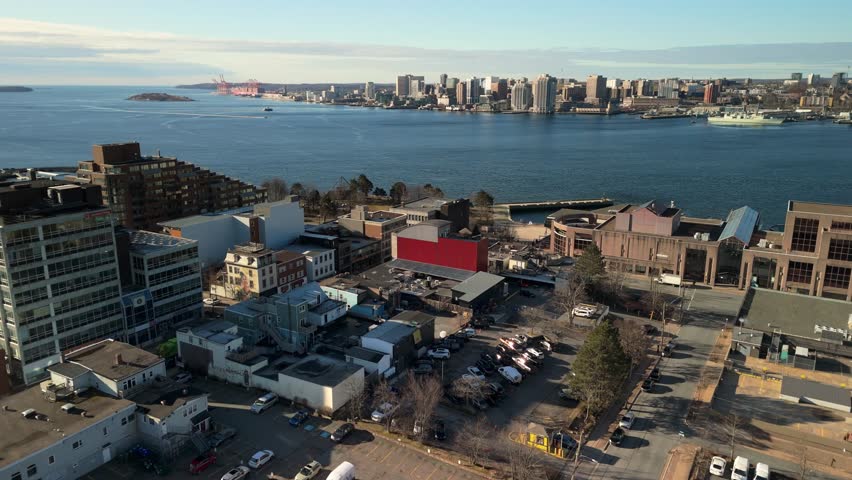 Scenic Drone Footage Of Skyscrapers, Luxury Boats, And Golden Trees On The Edge Of Halifax Harbor. Calm Waters And Clear Skies Enhance The Cinematic Feel Of This Canadian Coastal City.