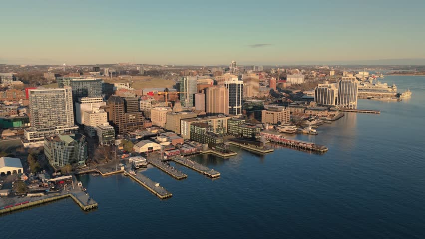Early Morning Drone Footage Of Halifax Skyline With Boats Cruising The Harbor, Nova Scotia. Golden Light Casts Shadows Across The Marina And City Buildings.Canada, Nova Scotia, North America, 