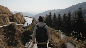A traveler walks down a narrow path beside flooded rice terraces in Longsheng, China - Powered by Shutterstock - Get 15% off with code: PIKWIZARD15
