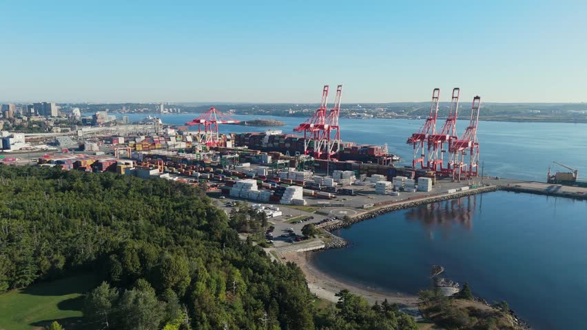 Drone Captures Maritime Logistics Hub Where Containers Are Lifted From Vessel. Halifax Port Is Canada East Coast Deep-Sea Gateway For Import Export Traffic.Cargo Ship Unloading In Halifax Nova Scotia
