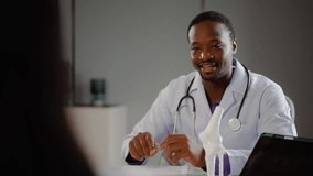 Cheerful doctor and young woman discuss her X-ray results on a tablet computer.  A man analyzes an MRI image to make a diagnosis for a patient, Young woman consulting trauma surgeon - Powered by Shutterstock - Get 15% off with code: PIKWIZARD15