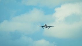 Airliner flying in partly cloudy sky with bright daylight. Passenger jet moving through atmosphere under blue weather. Twin engine aircraft descending with white clouds around - Powered by Shutterstock - Get 15% off with code: PIKWIZARD15