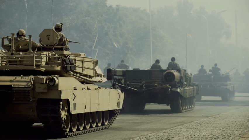 Powerful scene of military tanks moving through city streets, showcasing strength, discipline, and coordination in an urban environment — symbolizing defense, readiness, and national security.