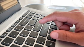Close-up of a woman finger pressing the Enter key on a laptop keyboard. - Powered by Shutterstock - Get 15% off with code: PIKWIZARD15