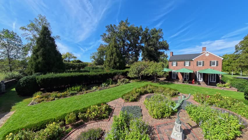 Experience the beautiful outdoor views of Shenandoah Gardens in Winchester, Virginia. Discover the lovely landscaping and historical architecture on a sunny day.
