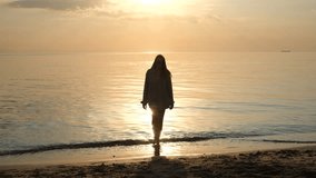 Portrait of a young woman greeting the dawn while walking along the seashore - Powered by Shutterstock - Get 15% off with code: PIKWIZARD15