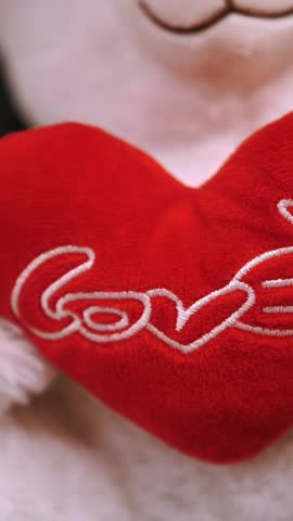 Happy Valentine's Day. Love concept. close-up. soft toy teddy bear, with red heart and writing word love on it. gifts, festive decor, decorations for Valentine's Day.
