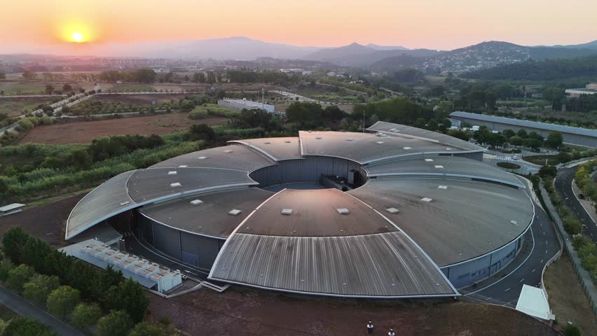 Drone footage of ALBA Synchrotron (ALBA II) particle accelerator, Spain — aerial push-in approach