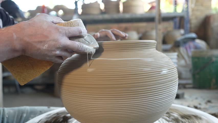 The potter gives a protective layer to seal the pores of the clay vessel