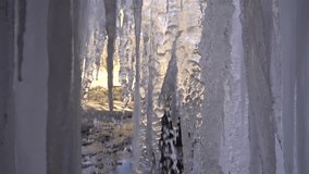 A frozen waterfall on a mountain river. The Bigar waterfall below Stara Planina is bound by ice. details of the icy stalactites around which the camera orbits. Unfrozen falling water flows between the - Powered by Shutterstock - Get 15% off with code: PIKWIZARD15