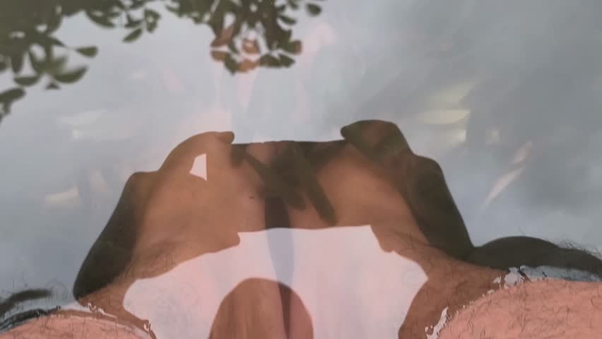 Garra rufa fish bite dead skin from feet during spa therapy.