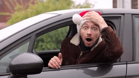 Young man in Christmas Santa hat driving car scared and amazed with open mouth for surprise. - Powered by Shutterstock - Get 15% off with code: PIKWIZARD15