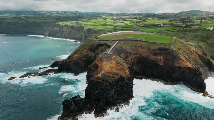 Landscape impressive rugged rocks with lighthouse and ocean in norther part Sao Miguel island, Azores
