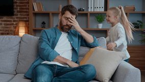 Caucasian family at home exhausted father frustrated active girl running playing adoption custody problem bad relationship stressful weekend dad holding head naughty daughter kid child run happy play - Powered by Shutterstock - Get 15% off with code: PIKWIZARD15