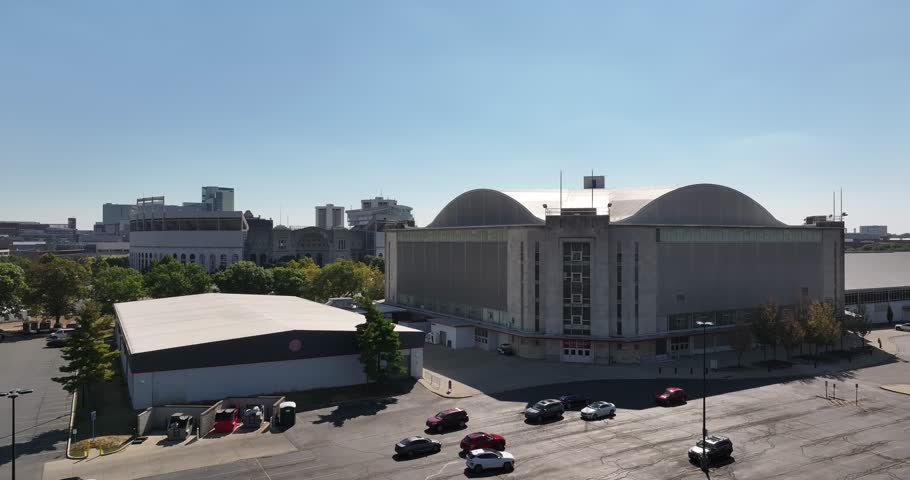 Columbus, United States - 14 September 2025: Aerial view of St. John Arena and Ohio Stadium, nestled among trees under a clear sky, casting soft shadows.