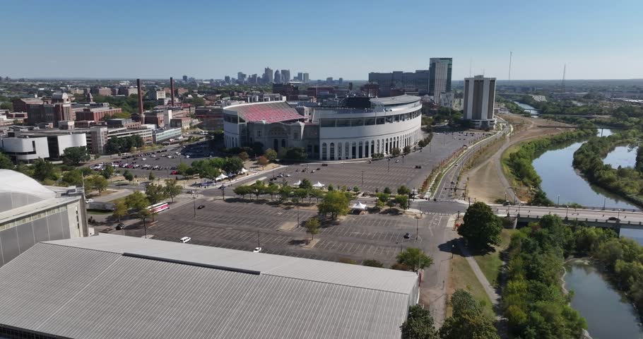 Columbus, United States - 14 September 2025: Aerial view of the iconic Ohio Stadium, surrounded by parking lots and the Olentangy River shimmering in the sunlight.