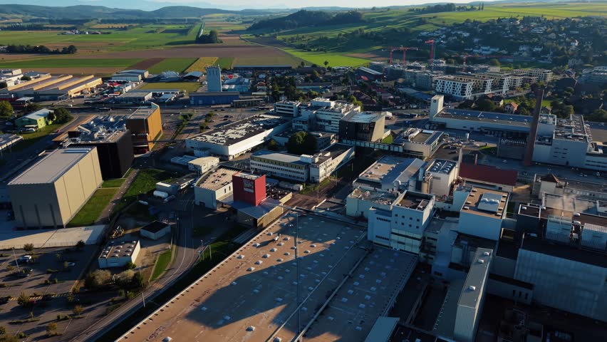 Orbe, Switzerland - 19 September 2025: Aerial view of the Nestle Product Technology Center, a mix of modern buildings set against the green landscape.