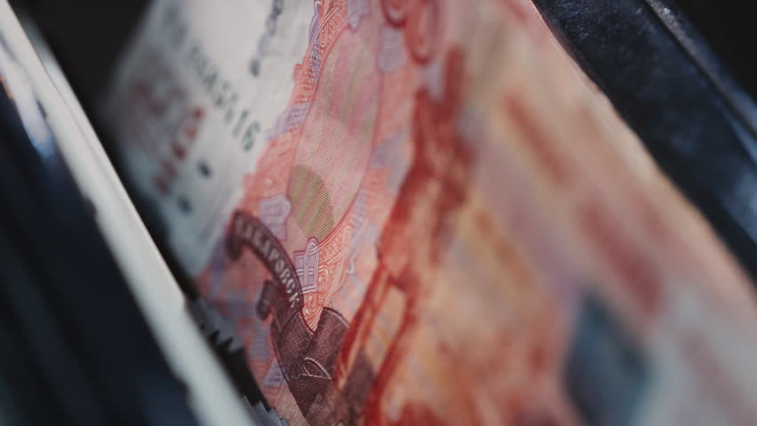 5000 Russian rubles in electronic money counting machine, accounting. Financial transaction in the bank. RUB Mortgage, Seller or broker considers finances. Economic crisis in Russia. Slow motion