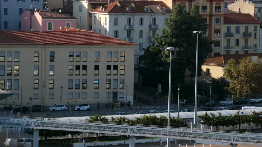 Scenic coastline of Corsica island seen from cruise ship with green hills rocky cliffs turquoise sea and coastal towns in sunlight Mediterranean travel destination natural landscape and summer view