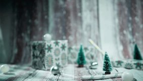 Festive Christmas scene featuring a charming hanging Merry Christmas sign with a gnome, miniature trees, and wrapped presents on a warm wooden table - Powered by Shutterstock - Get 15% off with code: PIKWIZARD15