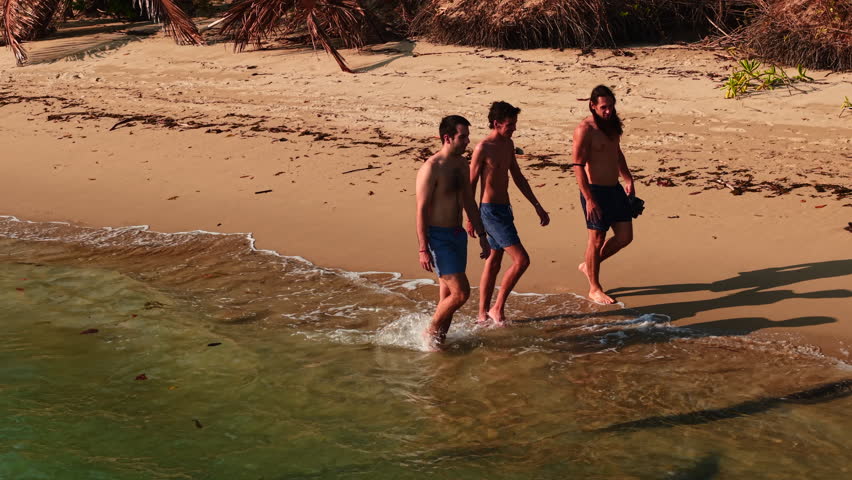 Tourists walking on wai chaek beach, koh chang district, trat province, thailand
