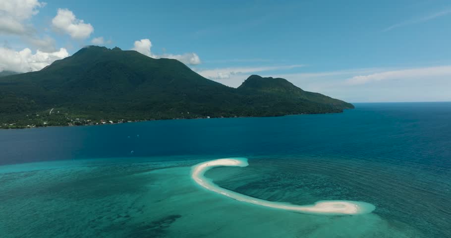 Top view of white sandbanks of White Island in Camiguin Island. Surrounded by turquoise water and waves. Philippines.