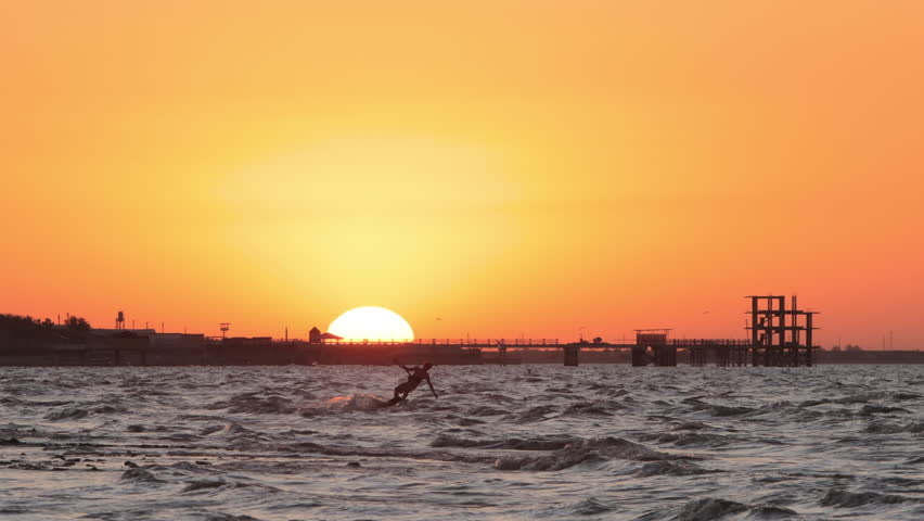 Extreme kitesurfer carving ocean waves at golden sunset tropical holiday paradise scene symbol of freedom adventure happiness lifestyle commercial summer vibes travel destination vacation inspiration