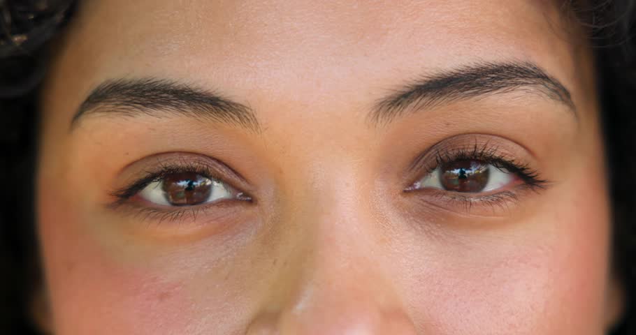 woman blinking during eye-tracking calibration, pulsing panels aligning then dispersing around eyes. Futuristic, immersive, technology, innovation, interface, digital, visualization