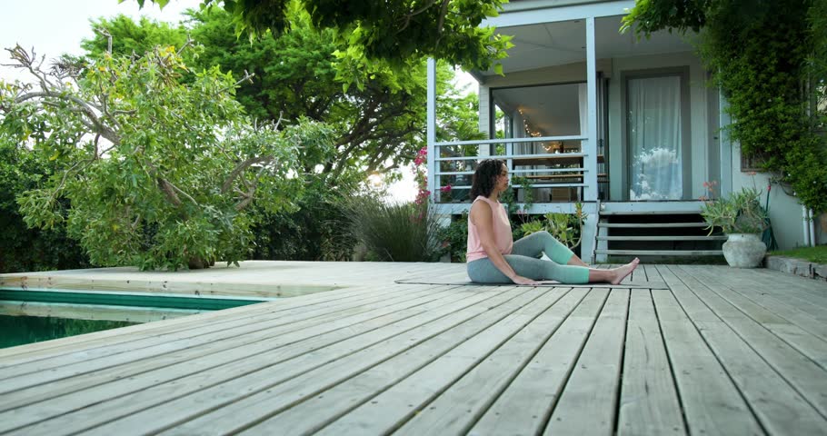 Green binary overlay appearing around woman doing yoga on mat, twisting torso then unwinding seated. Fitness, relaxation, mindfulness, wellness, tranquility, modern, outdoor