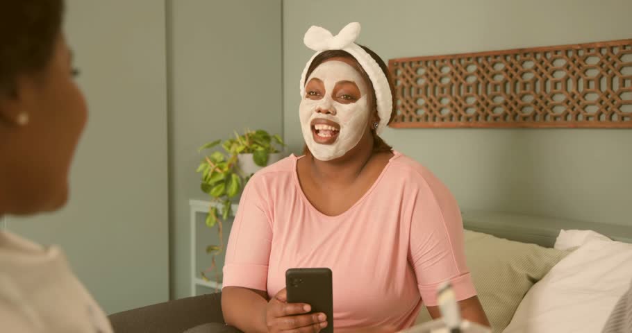 Main woman scrolling phone and causing glitchy code overlay while friends applying skincare brush. Digital, friendship, selfcare, casual, modern, upbeat, lifestyle