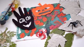 Child making pumpkins for the holiday of halloween. Funny crafts from paper. Halloween decor. Handicraft. The concept for Halloween. DIY. Children's art project, a craft for children. - Powered by Shutterstock - Get 15% off with code: PIKWIZARD15