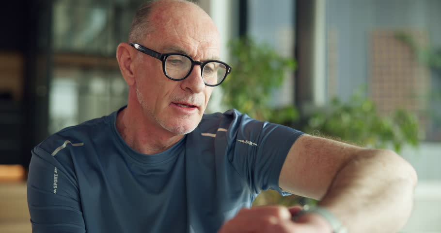 Athlete, senior man and smart watch for fitness, track performance and workout results. Elderly person, wristwatch and monitor for heart rate, exercise progress and timer with health stats at house