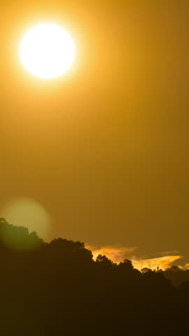 Timelapse of dramatic sunset with orange sky in a cloudy day.