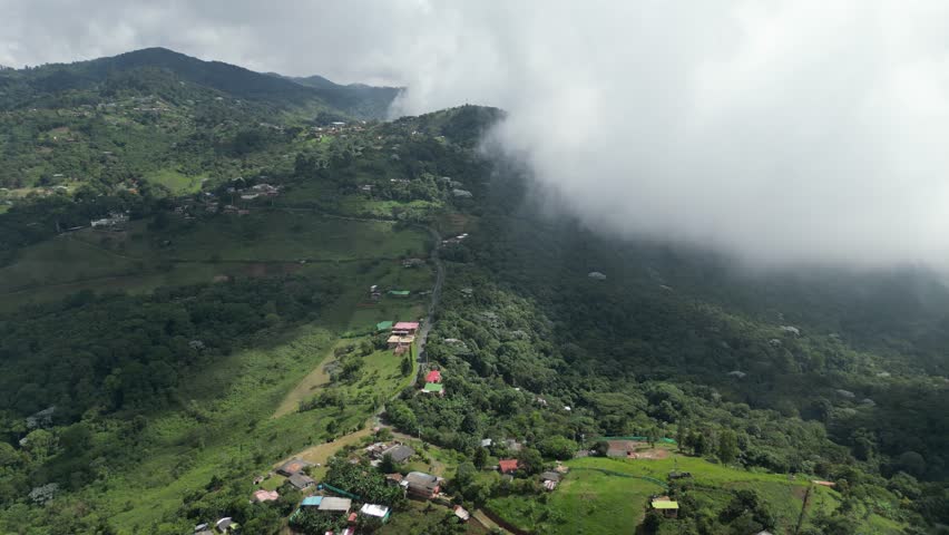 Aerial view of the lush hills around La Paz near Cali in the Valle del Cauca Department of Colombia, showing rural landscapes on a cloudy day
