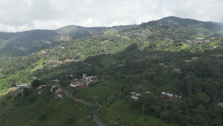 Aerial view of the lush hills around La Paz near Cali in the Valle del Cauca Department of Colombia, showing rural landscapes on a cloudy day