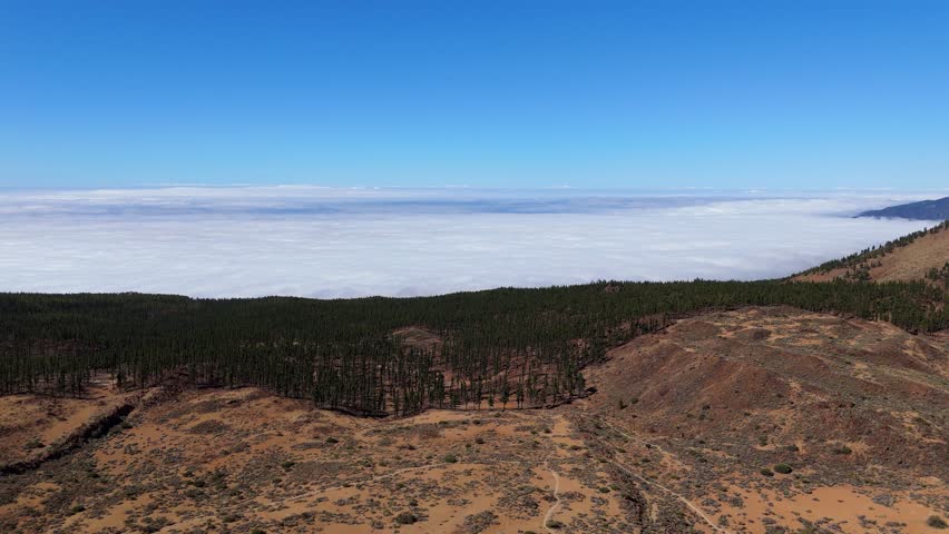 Clouds around the Island below the mountains, panoramic aerial video, Clouds and trees