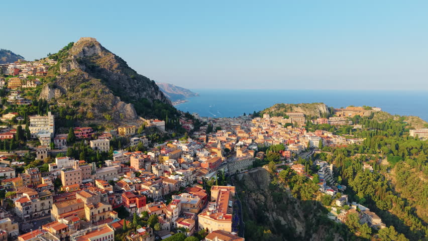 World wide famous Italian town of Taormina at sunset. Drone view
