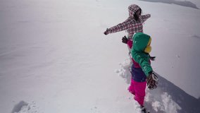 Two kids playing and making snow angels on fresh white snow, winter fun and childhood happiness - Powered by Shutterstock - Get 15% off with code: PIKWIZARD15