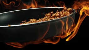 Fiery Thai basil pork chef tosses Pad Krapow Moo in blazing wok flames slow motion 4K - Powered by Shutterstock - Get 15% off with code: PIKWIZARD15