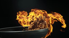 Thai street food action shot holy basil pork stir-fry flipped high with fire around wok slow motion 4K - Powered by Shutterstock - Get 15% off with code: PIKWIZARD15